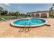 Community pool with an outdoor kitchen and lounge area at 800 Capri Isles Blvd # 124, Venice, FL 34292