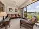 Relaxing sunroom featuring comfortable seating, a ceiling fan, and serene water views, perfect for unwinding at 800 Capri Isles Blvd # 124, Venice, FL 34292