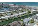 An aerial view of canal-front homes with docks and the beach skyline on the horizon at 832 Whitecap Cir # 5, Venice, FL 34285