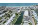 Aerial view of waterfront homes with private boat docks, lush landscaping, and tranquil canal waters at 832 Whitecap Cir # 5, Venice, FL 34285