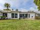 The backyard features a patio, lawn, and well-manicured landscape and canal views at 832 Whitecap Cir # 5, Venice, FL 34285