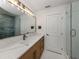 This modern bathroom features a long vanity, stylish lighting, and a beautiful, tiled walk-in shower at 832 Whitecap Cir # 5, Venice, FL 34285