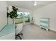 Bright bedroom with a white chair, and a teal painted antique dresser at 832 Whitecap Cir # 5, Venice, FL 34285