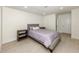 Bright bedroom featuring a comfortable bed with lavender bedding and simple modern decor at 832 Whitecap Cir # 5, Venice, FL 34285