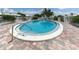 Enjoy the community pool with clear blue water, surrounded by a paved deck and privacy fencing at 832 Whitecap Cir # 5, Venice, FL 34285