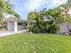 Charming home with tropical landscaping, well-maintained lawn, and covered parking at 832 Whitecap Cir # 5, Venice, FL 34285