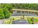 Aerial view of a backyard with a pool and a scenic view of the pond and lush greenery beyond at 9019 39Th Street Cir E, Parrish, FL 34219
