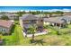 A stunning backyard includes a covered patio, lush green landscaping, and comfortable seating area at 9019 39Th Street Cir E, Parrish, FL 34219