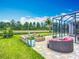 Beautiful backyard featuring a fire pit, comfortable seating, a screened patio, and a serene pond view at 9019 39Th Street Cir E, Parrish, FL 34219