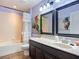 Bathroom with a marble vanity, large mirror, and decorative shower curtain at 9019 39Th Street Cir E, Parrish, FL 34219