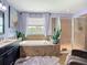 Spacious bathroom with soaking tub, walk-in shower, and stylish fixtures, creating a spa-like experience at 9019 39Th Street Cir E, Parrish, FL 34219
