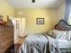 Comfortable bedroom with an upholstered headboard, wood floors, and a dresser at 9019 39Th Street Cir E, Parrish, FL 34219