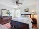 Bedroom with hardwood floors, large bed, and natural light at 9019 39Th Street Cir E, Parrish, FL 34219