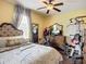 Cozy bedroom with ceiling fan, exercise equipment, and stylish decor creating a welcoming atmosphere at 9019 39Th Street Cir E, Parrish, FL 34219