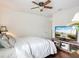 Cozy bedroom with a ceiling fan, white linens, and a TV on a stand at 9019 39Th Street Cir E, Parrish, FL 34219