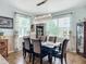 The dining room showcases a modern chandelier and large windows with decorative curtains at 9019 39Th Street Cir E, Parrish, FL 34219