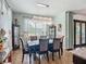 Formal dining area features an elegant chandelier, display cabinets, and views to the outside at 9019 39Th Street Cir E, Parrish, FL 34219