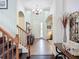 Inviting entryway with tiled floor, chandelier, staircase, and decorative archways creates a welcoming ambiance at 9019 39Th Street Cir E, Parrish, FL 34219