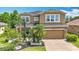 Inviting two-story home with a well-maintained yard, mature landscaping, and a cozy porch at 9019 39Th Street Cir E, Parrish, FL 34219
