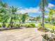 Lush landscaped front yard with vibrant plants and trees, creating a welcoming curb appeal and a touch of nature at 9019 39Th Street Cir E, Parrish, FL 34219