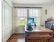 A cozy home office features a wooden desk and ample natural light from a window overlooking the lush outdoors at 9019 39Th Street Cir E, Parrish, FL 34219