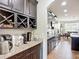 Modern kitchen features granite countertops, dark cabinets, stainless steel appliances, and convenient wine storage at 9019 39Th Street Cir E, Parrish, FL 34219