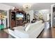 Inviting living room boasts a large entertainment center, white sofa, and staircase to the upper level at 9019 39Th Street Cir E, Parrish, FL 34219