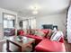 Cozy living room with a red sofa, a coffee table, and a view to another room at 9019 39Th Street Cir E, Parrish, FL 34219