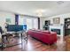 Living room featuring a fireplace, a red sofa, and a chandelier at 9019 39Th Street Cir E, Parrish, FL 34219