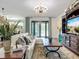 Comfortable living room setting showcases an entertainment center, large couch, and sliding glass doors to the outside at 9019 39Th Street Cir E, Parrish, FL 34219