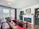 Comfortable living room with a red sofa, a fireplace, and a large coffee table at 9019 39Th Street Cir E, Parrish, FL 34219