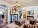 Open-concept living room with a fireplace, hardwood floors, and comfortable seating offers a relaxing atmosphere at 9019 39Th Street Cir E, Parrish, FL 34219