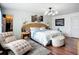 Elegant main bedroom with wood floors, a tufted chaise lounge, a decorative light fixture, and ample natural light at 9019 39Th Street Cir E, Parrish, FL 34219