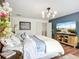 Beautifully decorated main bedroom with beach view on the TV, soft bedding and a serene and peaceful ambiance at 9019 39Th Street Cir E, Parrish, FL 34219