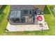 An aerial view of a screened patio and brick pavers that includes comfortable seating and a fire pit at 9019 39Th Street Cir E, Parrish, FL 34219