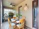 Enclosed patio featuring a dining table set, tile flooring, and neutral wall decor at 9019 39Th Street Cir E, Parrish, FL 34219