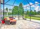 Screened in patio featuring outdoor seating and fire pit area with tranquil backyard views at 9019 39Th Street Cir E, Parrish, FL 34219