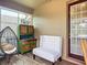 Cozy patio featuring a modern chair, decorative cabinet, and neutral-colored bench at 9019 39Th Street Cir E, Parrish, FL 34219