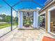 Fully screened patio featuring a shaded pergola with curtains and an outdoor firepit at 9019 39Th Street Cir E, Parrish, FL 34219