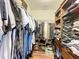Walk-in closet with hanging clothes and custom wooden shelving at 9019 39Th Street Cir E, Parrish, FL 34219