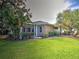 Beautiful home with a screened-in patio and a well-maintained backyard with a lush lawn at 912 Barclay Ct, Venice, FL 34293