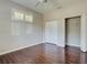 Bedroom featuring hardwood floors, a closet, and a shuttered window at 912 Barclay Ct, Venice, FL 34293