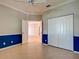 Spacious bedroom featuring tiled floors, a ceiling fan, closet, and an open door to an additional room at 912 Barclay Ct, Venice, FL 34293