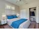Nicely staged bedroom featuring wood floors, ceiling fan, closet and shuttered windows at 912 Barclay Ct, Venice, FL 34293