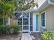 A beautiful home exterior featuring a screened-in lanai, a garden, and well-maintained landscaping at 912 Barclay Ct, Venice, FL 34293
