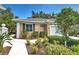 Charming home with a landscaped front yard, walkway and tiled roof at 912 Barclay Ct, Venice, FL 34293