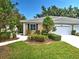 Inviting home exterior featuring a well-manicured lawn and appealing landscaping at 912 Barclay Ct, Venice, FL 34293