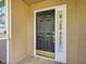 View of the front door with sidelight and gold accents at 912 Barclay Ct, Venice, FL 34293