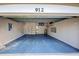 Spacious two-car garage with painted floor and walls, plus ample shelving and storage space at 912 Barclay Ct, Venice, FL 34293