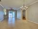Open living room with tile flooring, neutral walls, and sliding glass doors to outdoor patio at 912 Barclay Ct, Venice, FL 34293